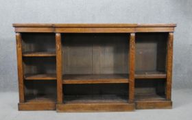 A Victorian oak breakfront bookcase, with acanthus leaf corbels, over adjustable shelves, on a