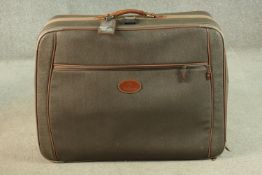 A Mulberry scotchgrain leather travelling case with wheels and spring loaded extending handle,