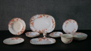 A hand painted Victorian stylised scrolling foliate and floral design part dinner service with