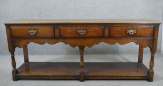 A circa 2000 18th century style oak dresser base, by Titchmarsh & Goodwin, with three long drawers