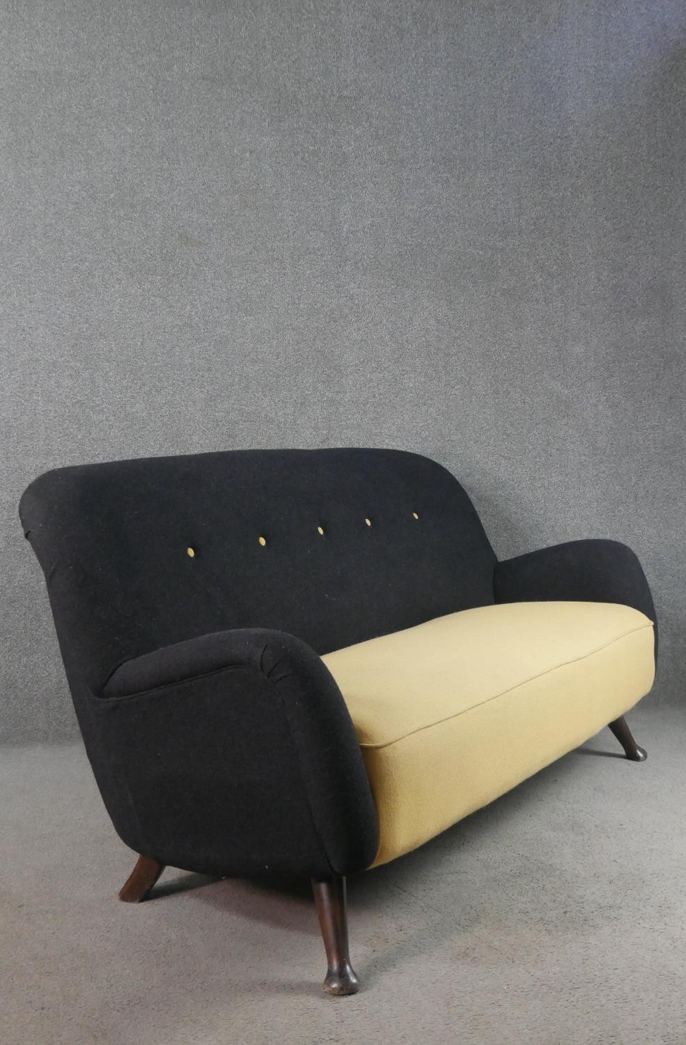 A circa 1950s two seater sofa,, the buttoned back upholstered in black fabric, over a yellow - Image 5 of 6