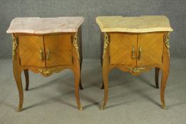 A pair of Louis XV style quarter veneered marble topped bedside tables, with serpentine marble