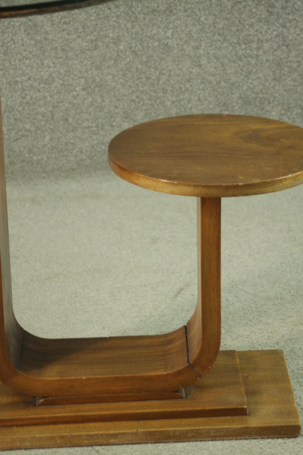 An Art Deco teak table and stool, with a circular glass table top, on a support which curves up to a - Image 3 of 8