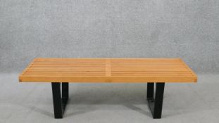 George Nelson (American, 1908-1986), a slatted teak bench, on ebonised legs. H.35 W.120 D.47cm