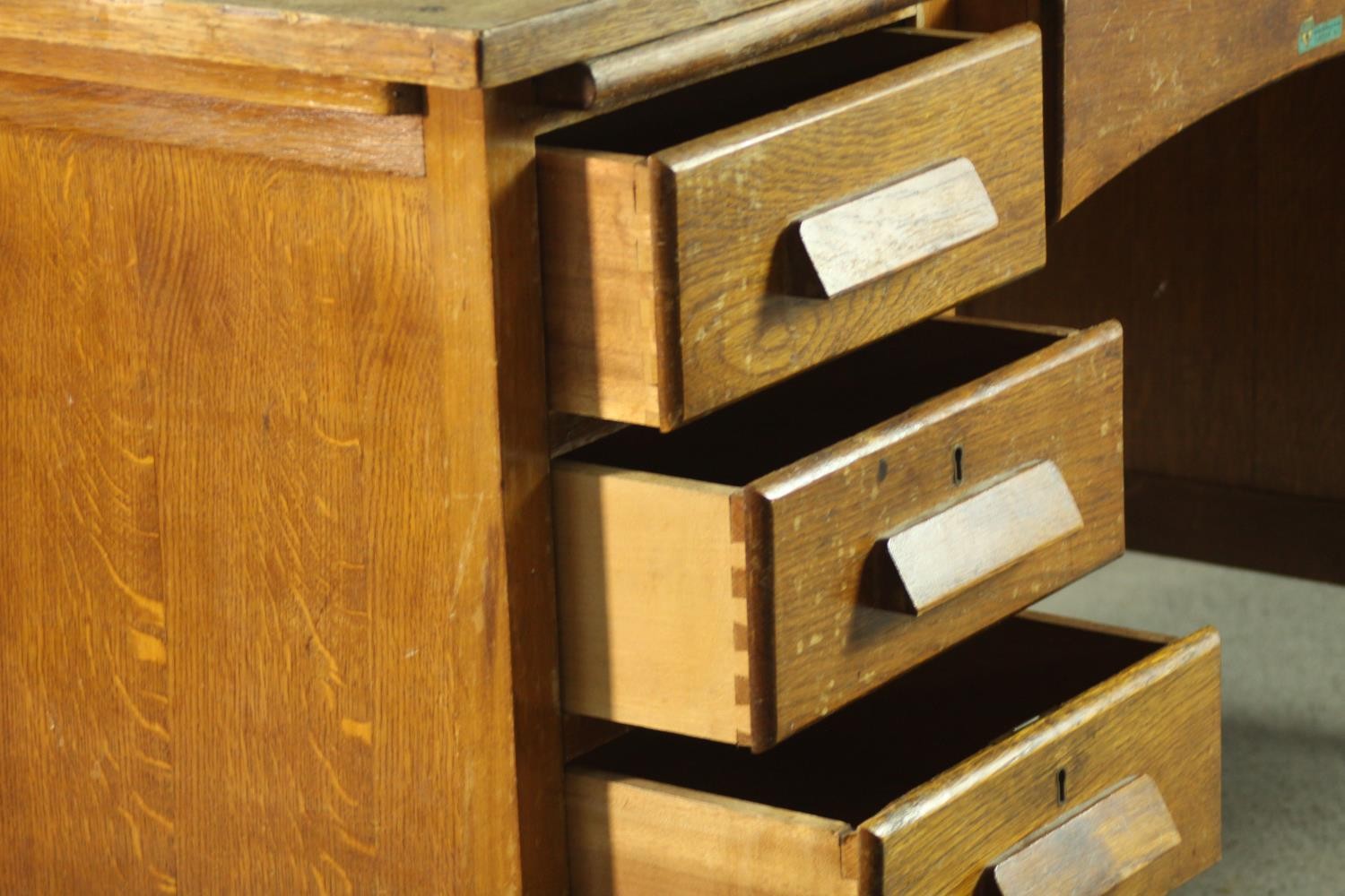 A circa 1940s oak desk, the rectangular top over two slides, and an arrangement of seven drawers - Image 5 of 8