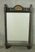 A Victorian Aesthetic movement ebonised and parcel gilt mirror, with a rectangular bevelled plate,