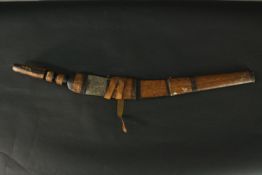 An African tribal sword and leather scabbard, with carved handle and engraved steel blade. L.90cm.