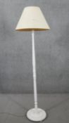 A painted carved standard lamp with cream shade. H.180 Diam.36cm