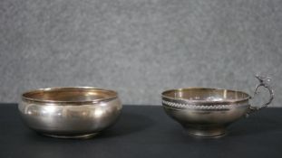 Two pieces of Continental silver, including an Egyptian handled soup cup with stylised leaf design