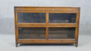 A Globe Wernicke style oak stacking bookcase, of two tiers, with glazed doors.