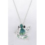 A silver frog pendant set with dark green, pale green and white cubic zirconia's. Black enamel for