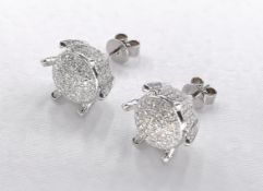 A pair of 14 carat white gold and diamond stylised flower earrings. The two earrings set with a