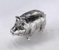 A miniature model of a silver pig with engraved detailing and tusks. Stamped sterling.