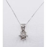 A French Art Deco 9 carat white gold diamond star pendant with 18 carat white gold trace chain.