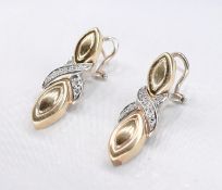 A pair of Italian 14 carat yellow gold and diamond X motif drop earrings. Each earring set with