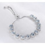 A white metal (tests as silver) cubic zirconia and aquamarine articulated bracelet. Set with