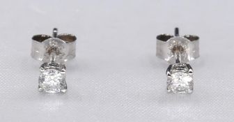 A pair of 18ct white gold and diamond stud earrings. Each earring set with a round brilliant cut