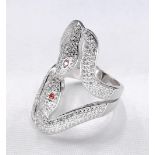 A contemporary silver and cubic zirconia double kissing snake ring. The eyes set with orange cubic