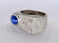 A 14 carat white gold diamond and star sapphire dress ring, set with a round cabochon star