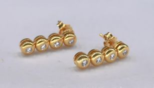 A pair of 18 carat yellow gold and diamond articulated drop earrings. Each earring set with four