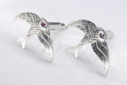 A pair of hinged silver swallow cufflinks with ruby eyes. Stamped Sterling, Silver.