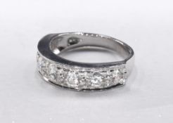 A white metal (tests as 18 carat) diamond half eternity ring. Set with seven round brilliant cut