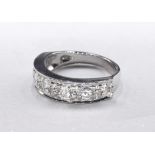 A white metal (tests as 18 carat) diamond half eternity ring. Set with seven round brilliant cut