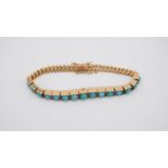 A Russian 9 carat yellow gold and turquoise articulated bracelet. Set with fifteen round turquoise