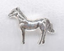 A miniature model of a silver horse with engraved detailing. Stamped sterling.