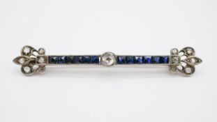 An Edwardian yellow and white metal (tests as 9 carat and silver) sapphire and old cut diamond bar