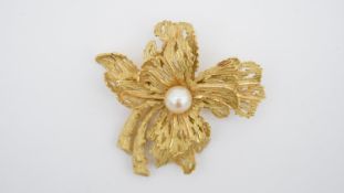 An 18 carat gold and cultured pearl floral spray brooch by Garrard & Co, the textured gold body