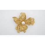 An 18 carat gold and cultured pearl floral spray brooch by Garrard & Co, the textured gold body