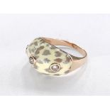 A 14 carat yellow gold leopard enamel and diamond ring. Set with three round brilliant cut