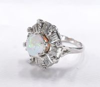 An 18 carat white gold and platinum opal and diamond dress ring. Set to centre with a round opal