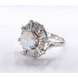 An 18 carat white gold and platinum opal and diamond dress ring. Set to centre with a round opal