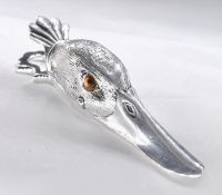 A silver plated hinged letter clip in the form of a ducks head, with yellow glass eyes.