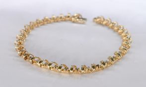 A 14 carat yellow gold and diamond articulated openwork line bracelet. Set with thirty three round