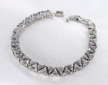 A silver and trillion cut cubic zirconia articulated bracelet. Set with forty two trillion cut cubic