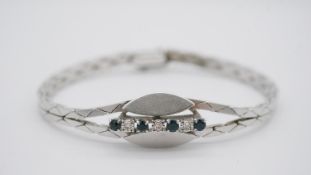 A vintage 14 carat white gold, sapphire and diamond abstract design articulated bracelet. Set with