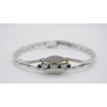 A vintage 14 carat white gold, sapphire and diamond abstract design articulated bracelet. Set with