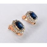 A pair of yellow metal (tests 9ct) cluster sapphire and diamond clip on earrings. Set to centre with