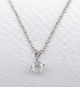A 14 carat white gold diamond solitaire pendant with a silver trace chain. The pendant set with a