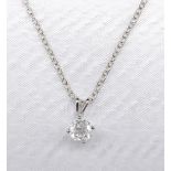 A 14 carat white gold diamond solitaire pendant with a silver trace chain. The pendant set with a