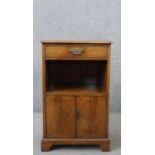 A 20th century George III style bedside cabinet, the top with a tooled blue/green leather inset,