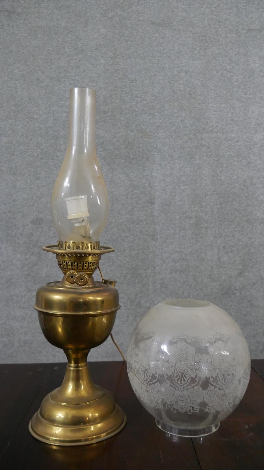 A Victorian brass converted oil lamp, with a globular etched glass shade. H.52 W.15cm - Image 5 of 6