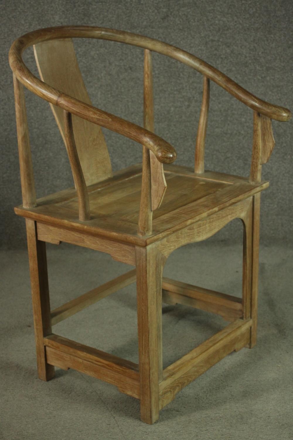 A pair of Chinese teak horseshoe back armchairs, with a plain splat back, the legs joined by - Image 4 of 17