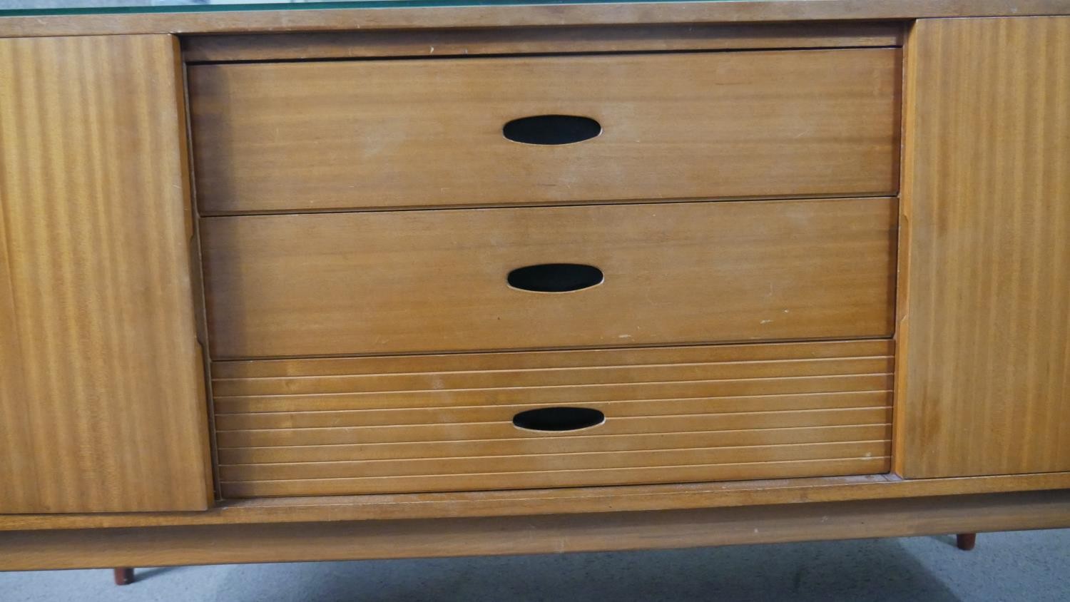 A circa 1960s teak dressing table, with a frameless mirror over three short drawers flanked by - Image 6 of 8