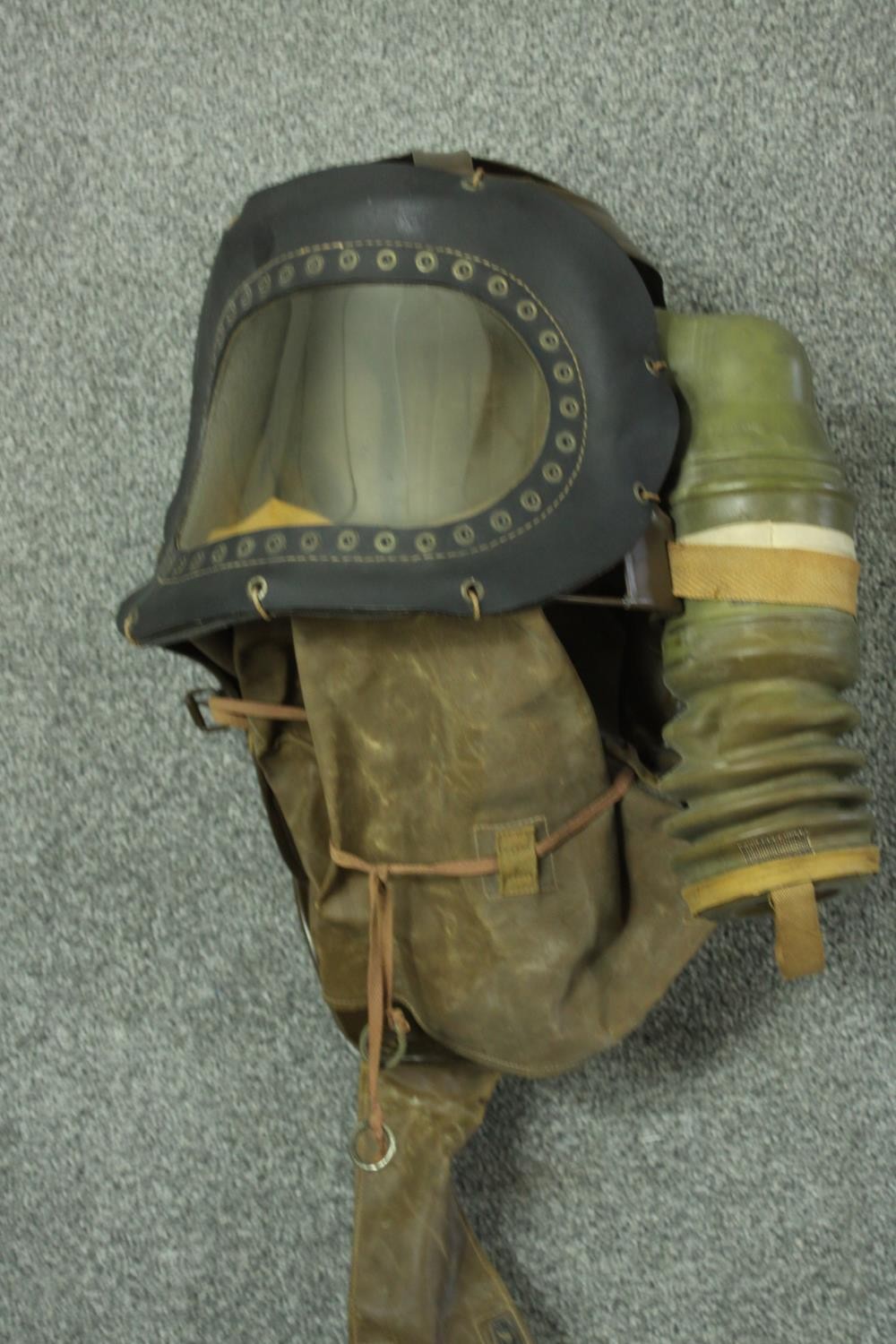 A WWII childs respirator with military issue gas mask and WWII helmet, stamped FG. H47 W.40cm. ( - Image 4 of 9