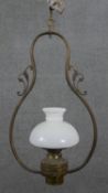 A Colonial brass hanging lamp, the frame of pear form, with a milk glass shade. H.74 W.40cm