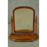 A Victorian mahogany swing framed toilet mirror, with bobbin turned supports. H.71 W.66cm.
